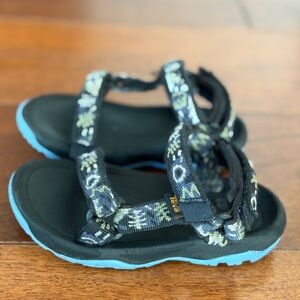 Teva Black and Patterned Sandals with Blue Soles